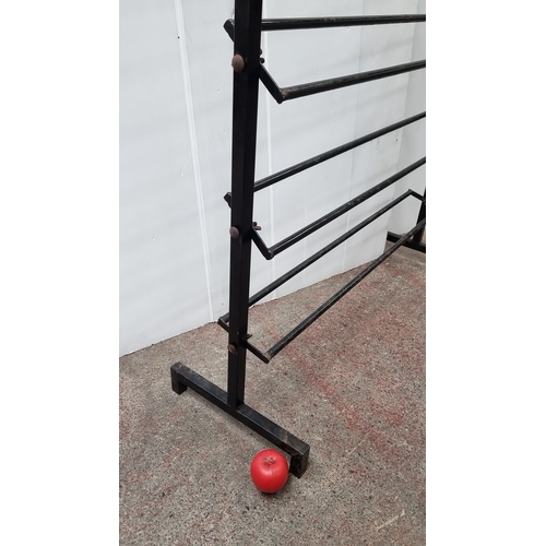 444 - Vintage metal retail display rack with six adjustable horizontal bars.