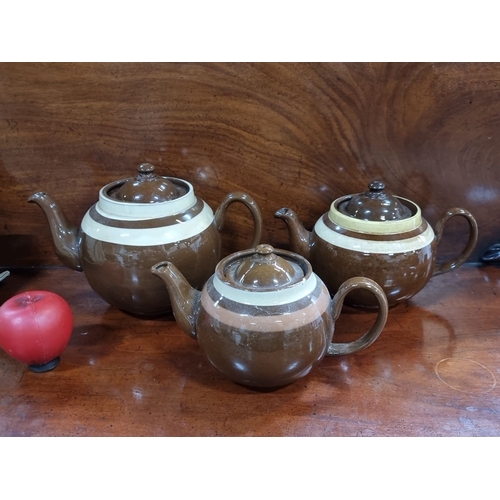 448 - Set of three brown ceramic teapots with beige bands, marked 