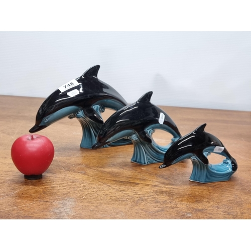 748 - A trio of graduated vintage 1960s ceramic dolphins produced by Poole pottery England. In good order,... 