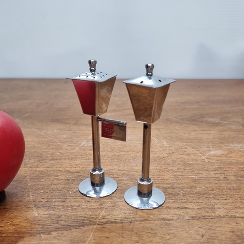 766 - A pair of quirky salt and pepper shakers in the form of antique street lamps.