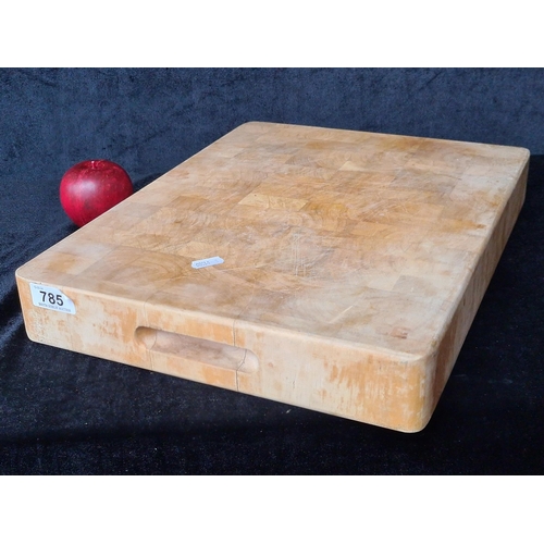 785 - A large commercial quality wooden butchers block. Stamped indistinctly to corner .