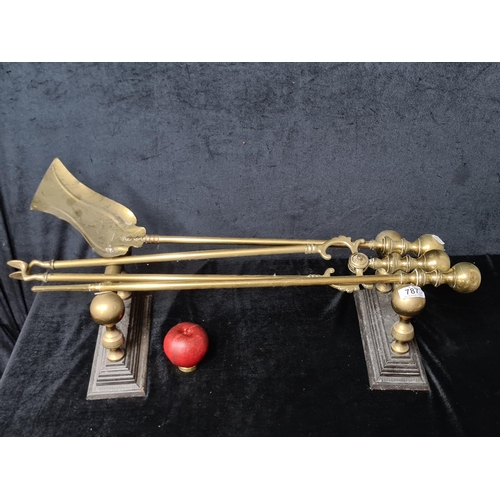 787 - An antique, Brass fire irons including a shovel and tongs, together with a pair of fire dogs.