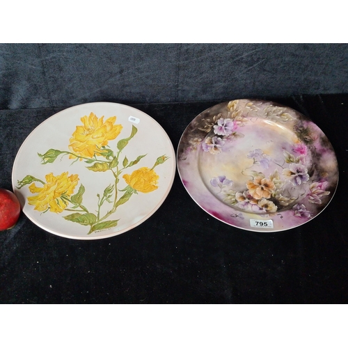 795 - Two large hand thrown ceramic plates with hand painted detailing signed 