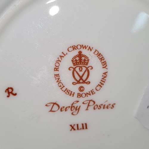 809 - Seven Royal Crown Derby pieces including six pin dishes and a milk jug. All featuring the 