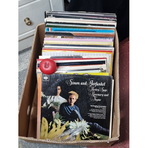 770 - A large collection of 50 vinyl records from artists such as Simon and Garfunkel, Whitney Houston,  E... 