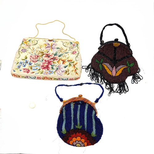 987 - Three vintage ladies clutch bags including two beaded examples and one tapestry example.