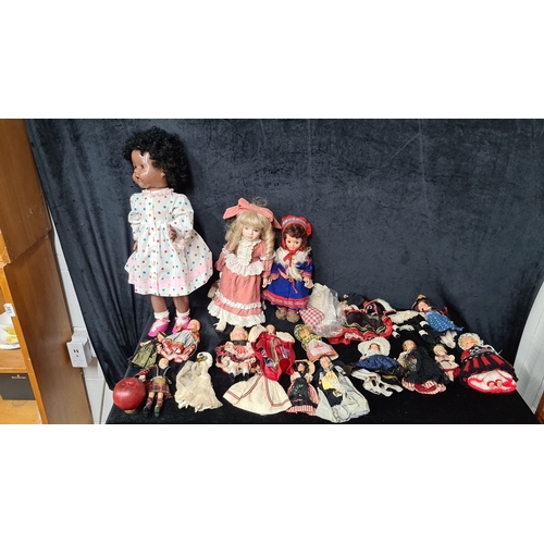 813 - Collection of 20 vintage dolls, including a large polka-dotted doll, two medium-sized Victorian-styl... 