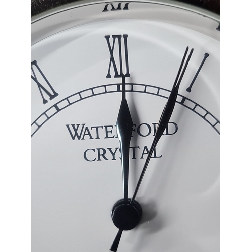 825 - Waterford Crystal clock, cut glass design with Roman numeral dial, gold-tone accents. Oval shape.