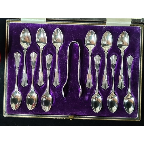 831 - Set of 12 Silver plated teaspoons in a fitted case with matching tongs. The case has a velvet interi... 