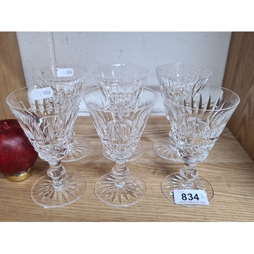 834 - Set of six cut crystal stemmed glasses with intricate faceted design and flared rims.