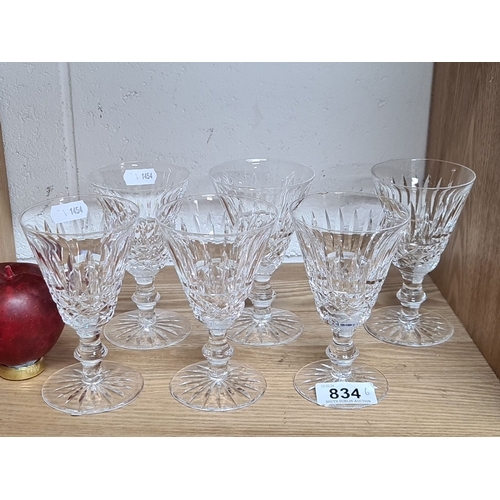 834 - Set of six cut crystal stemmed glasses with intricate faceted design and flared rims.