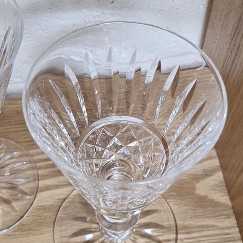 834 - Set of six cut crystal stemmed glasses with intricate faceted design and flared rims.