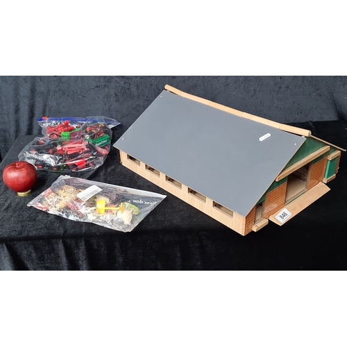 846 - Wooden barn model with accessories. Includes bags of plastic toy farm animals and machinery.