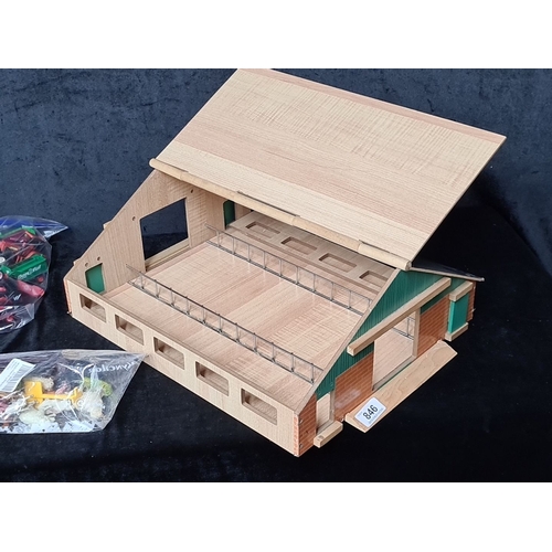 846 - Wooden barn model with accessories. Includes bags of plastic toy farm animals and machinery.