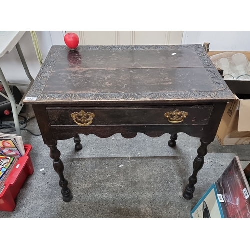 882 - Star lot :Antique carved oak side table with a single drawer, brass handles, and turned legs, from t... 