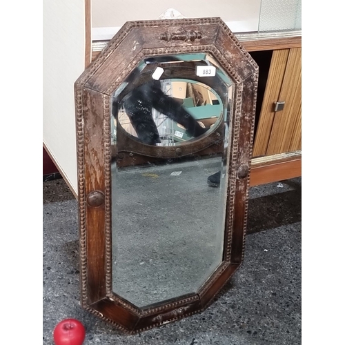 883 - Early 20th Century oak framed mirror with an octagonal shape, featuring carved detailing around the ... 