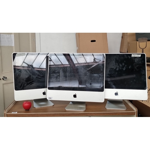 890 - Set of three Apple iMac desktop computers with 21-inch screens. Each features aluminum casings and b... 