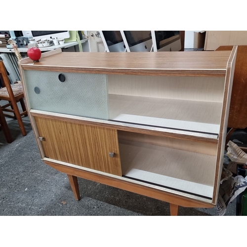 891 - Mid-Century Modern sideboard with sliding glass and wooden doors, featuring adjustable shelving. Mad... 