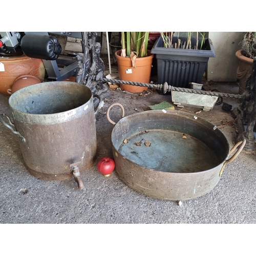 917 - A set of two vintage copper pots, each featuring sturdy handles. One pot includes a spout for dispen... 