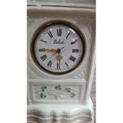 962 - Set includes Belleek porcelain clock with Celtic design, two clear glass candlestick holders, two ce... 