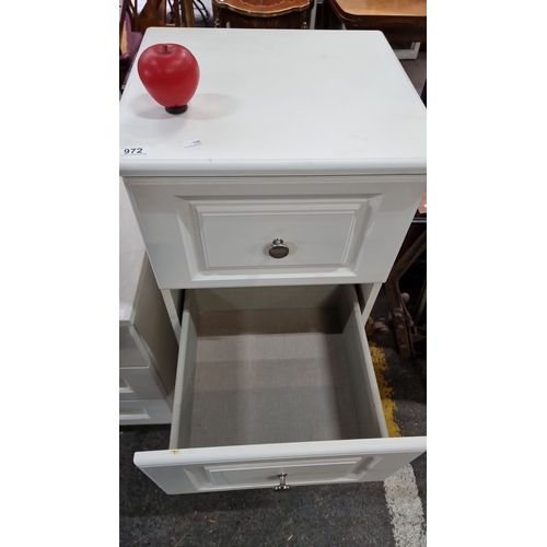 972 - White four-drawer chest with metal knob handles, featuring panelled drawer fronts. heavy, good quali... 