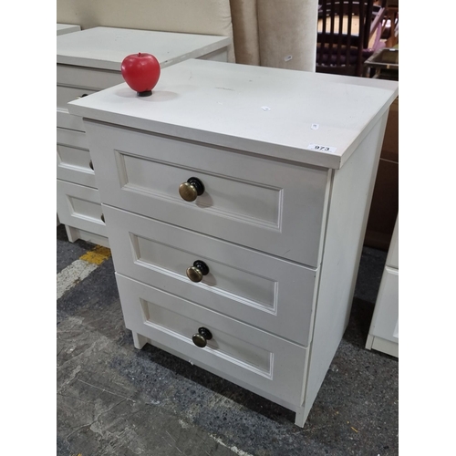 973 - White three-drawer wooden dresser with mixed metal knobs. It's a watch to the next pair if you need ... 