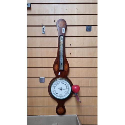 984 - Star Lot : An Early Victorian Mahogany wheel barometer with thermometer, featuring intricate inlays ... 