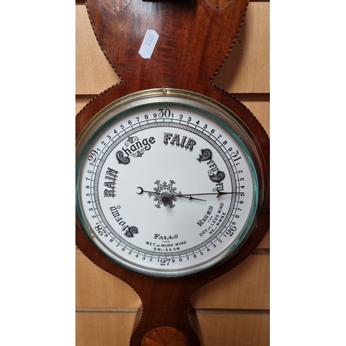 984 - Star Lot : An Early Victorian Mahogany wheel barometer with thermometer, featuring intricate inlays ... 