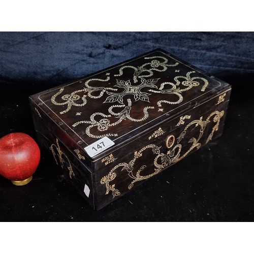 1015 - A beautiful example of an antique jewellery box in a dark fruit wood with intricate nlay to top. Wit... 