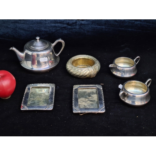 1017 - A lot of silver plated items including a tea service and two easel stamped photo frames.
Previous in... 