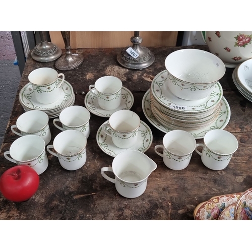 1091 - Set of vintage porcelain dinnerware, featuring a floral and garland pattern. Includes 8 cups, 9 sauc... 