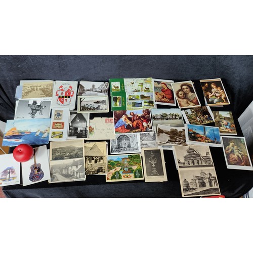 1101 - Mixed lot containing vintage postcards, stamps, and an old issue of 