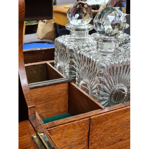 131 - Star lot : A fabulous antique Victorian tantalus with three square cut glass decanters, brass hardwa... 