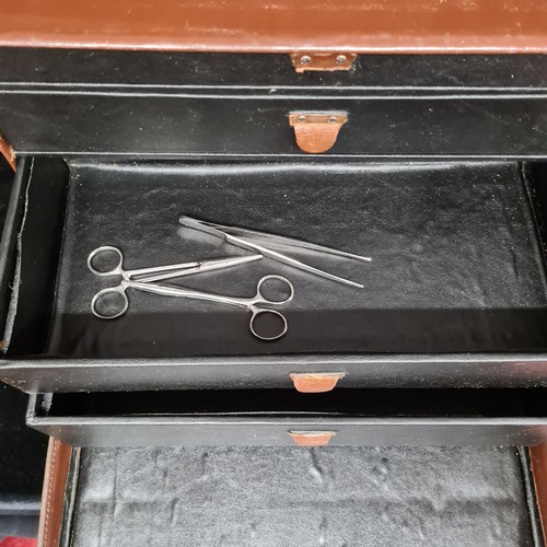 224 - A vintage leather travel doctor's medical box with four graduated drawers to interior with some vint... 