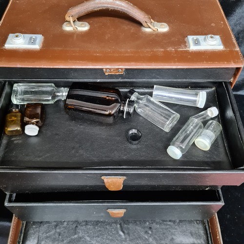 224 - A vintage leather travel doctor's medical box with four graduated drawers to interior with some vint... 