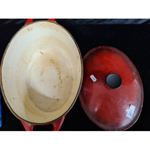 252 - A wonderful heavy cast iron enameled casserole dish. In attractive cherry wine red.