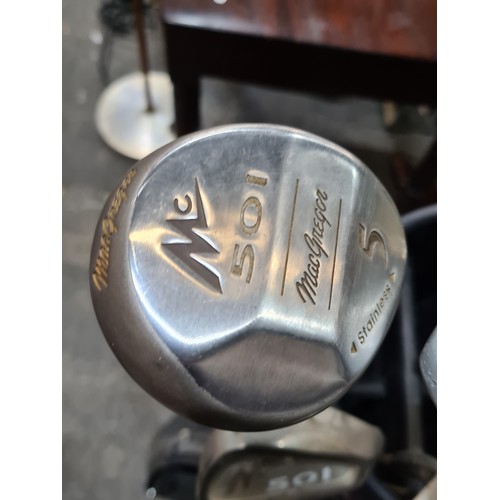 643 - A set of golf clubs including MacGregor irons and wedges, driver, 3 and 5 wood. Along with a Spaldin... 