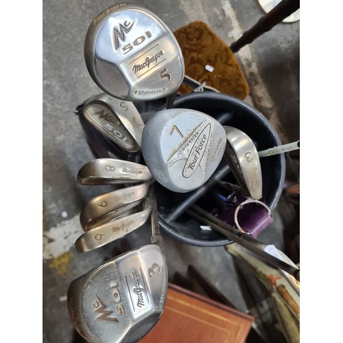 643 - A set of golf clubs including MacGregor irons and wedges, driver, 3 and 5 wood. Along with a Spaldin... 