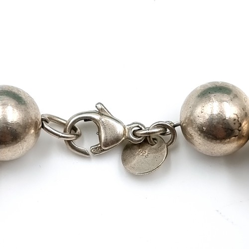 56 - A silver ball bracelet with 'Tiffany & Co.' marked clasp. Weight - 18.75 grams. Comes in Tiffany box... 