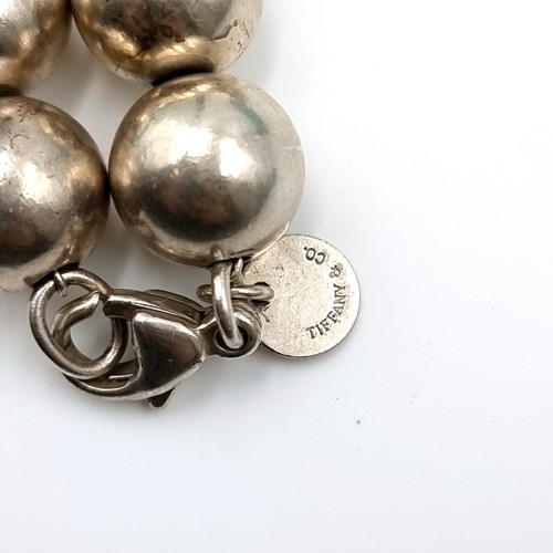 56 - A silver ball bracelet with 'Tiffany & Co.' marked clasp. Weight - 18.75 grams. Comes in Tiffany box... 