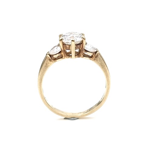 578 - A nine carat gold three stone cubic Zirconia stone ring. Ring size - O. Weight - 2.45 grams. Boxed.