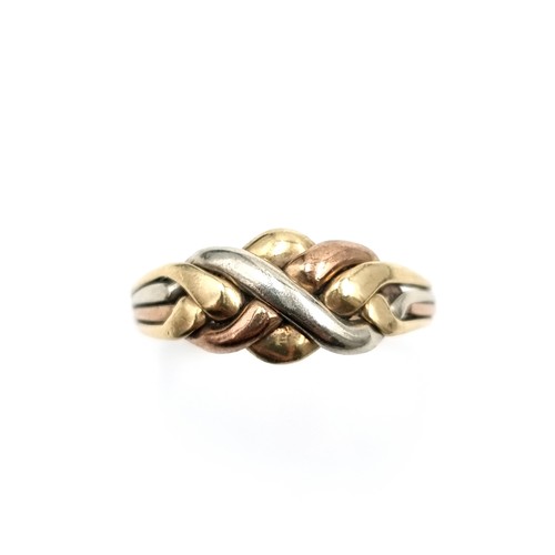 579 - A tri-colour nine carat gold twist set knot ring. Size - V. Weight - 2.89 grams. Boxed.