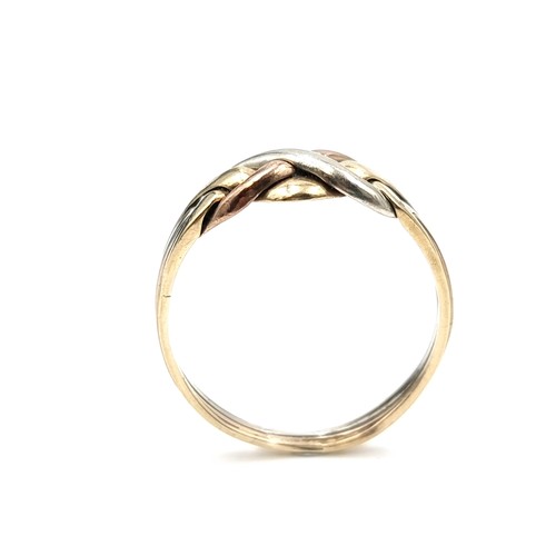 579 - A tri-colour nine carat gold twist set knot ring. Size - V. Weight - 2.89 grams. Boxed.