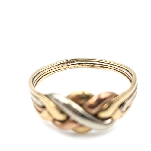 579 - A tri-colour nine carat gold twist set knot ring. Size - V. Weight - 2.89 grams. Boxed.