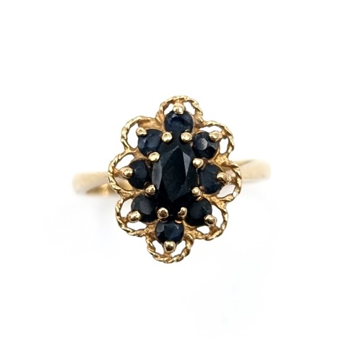 581 - Star Lot : A nice example of a vintage sapphire nine carat gold floral design ring. Size - P. Weight... 