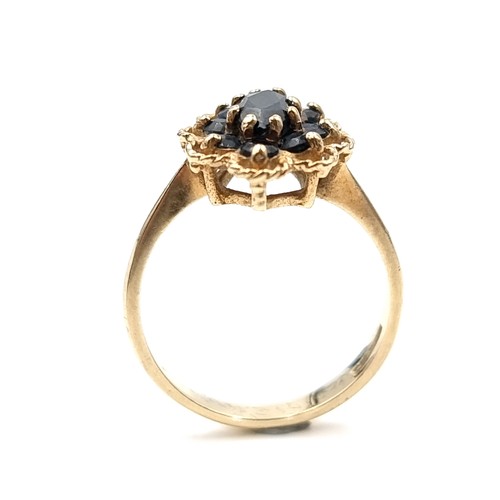 581 - Star Lot : A nice example of a vintage sapphire nine carat gold floral design ring. Size - P. Weight... 