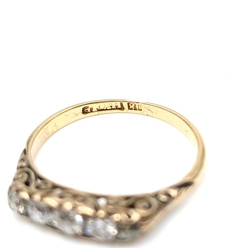 586 - Star Lot : A pretty vintage five stone diamond ring set in 18 carat gold. Est. weight of diamonds is... 