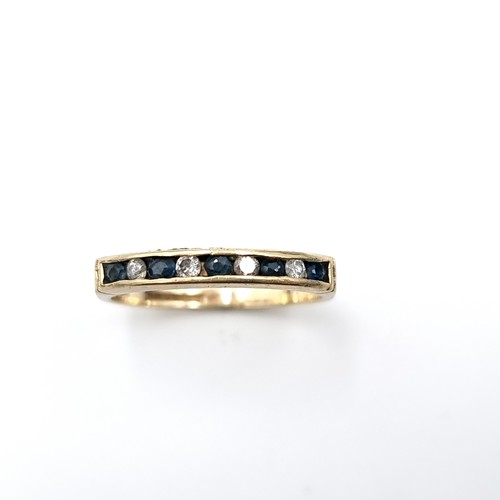 588 - Star Lot : A pretty diamond and sapphire eternity ring set in nine carat gold. Ring size - K. Weight... 