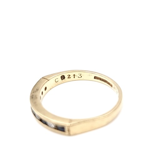 588 - Star Lot : A pretty diamond and sapphire eternity ring set in nine carat gold. Ring size - K. Weight... 