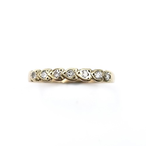 589 - Star Lot : An attractive half eternity diamond ring. Est weight of diamonds - 0.2 carats. Ring size ... 